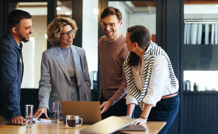 A male business supervisor holding a meeting with members of his team in an office after completing his business administration training