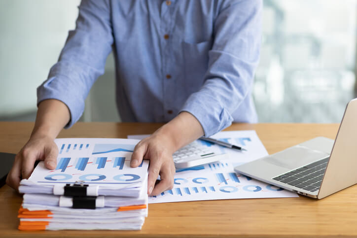 A male accounting clerk preparing financial reports after accounting training